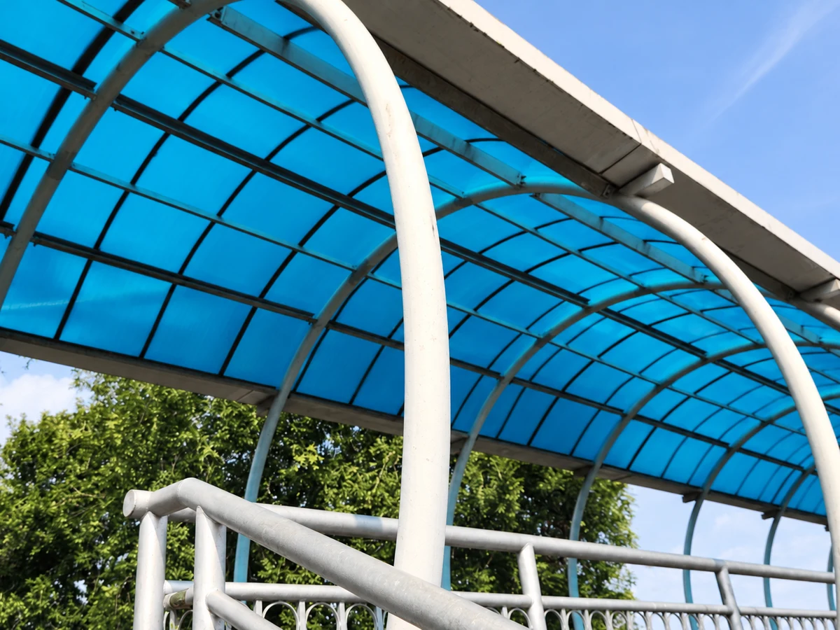 Mái che hành lang cầu đi bộ bằng tấm Polycarbonate rỗng Xanh hồ, nhìn từ phía dưới.